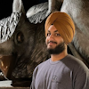 Headshot of Bawneet Singh with gryphon in background.