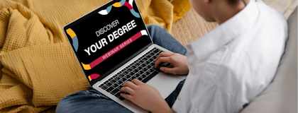 A student looking at a laptop screen that says "Discover Your Degree Webinar Series"