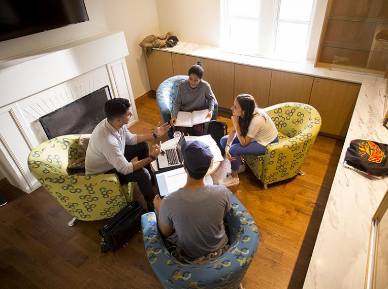 A group of four students studying together on campus