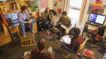 A group of students hang out in a Student Housing residence building at the University of Guelph.
